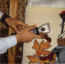 Anas shearing the weave pile at The Oriental Rug Gallery Ltd