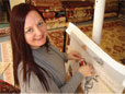 Sandre hand-weaving the rug knots on the Coat of Arms Weaving