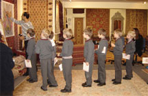 Schoolchildren weave rug knots at The Oriental Rug Gallery Ltd